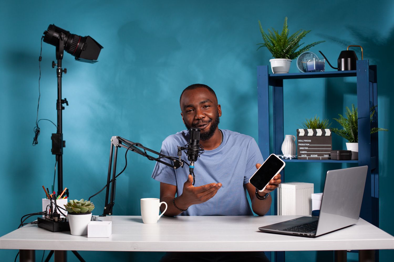 man discussing something with a colleague in front of a laptop