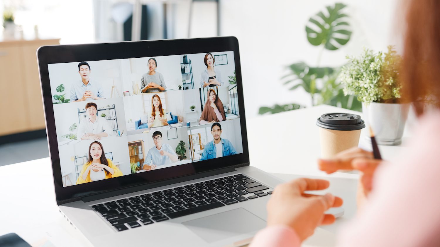 a woman  in a meeting with other co-workers discussing charts and graphs, representing market research.