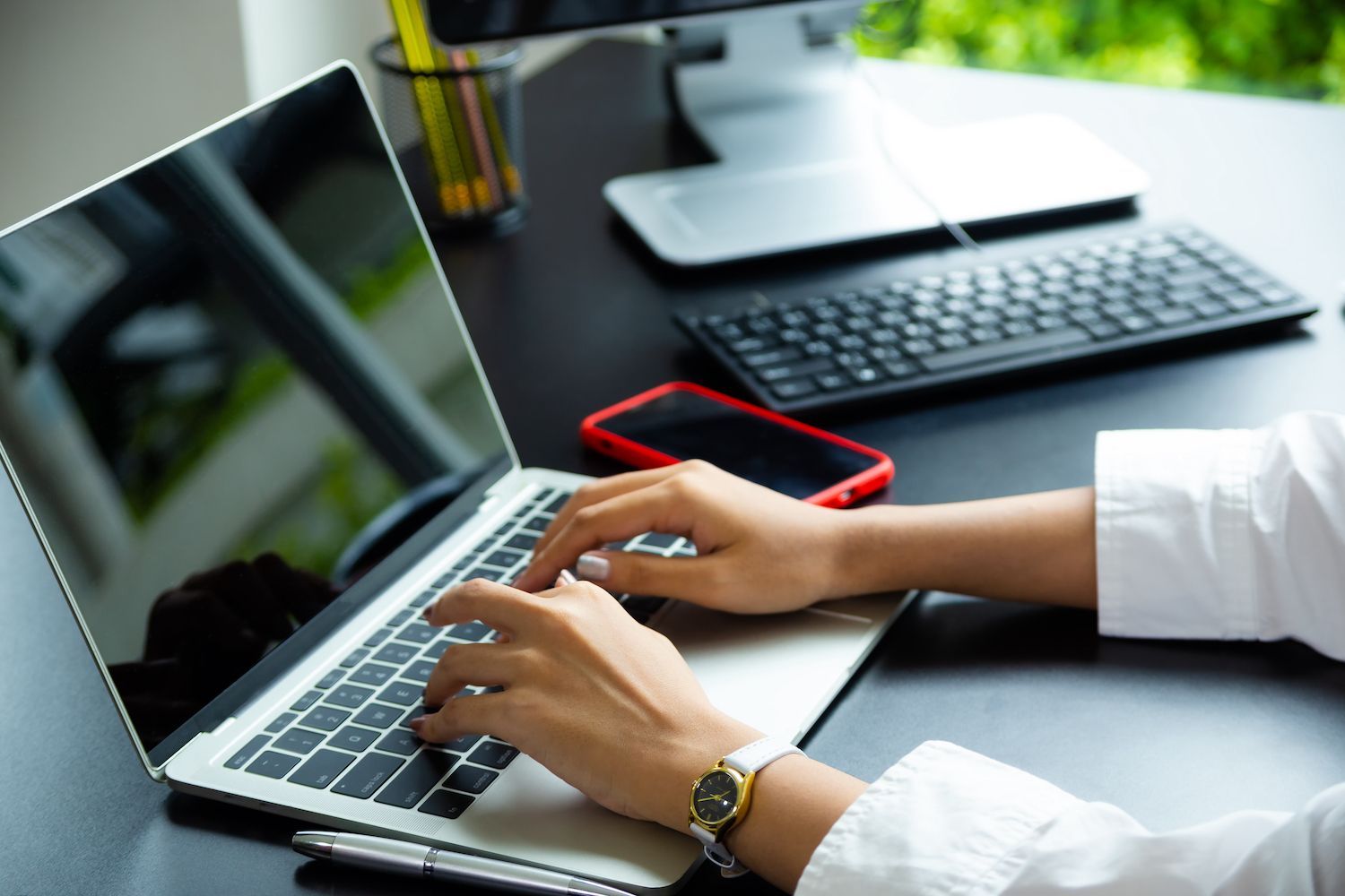 AI-generated image of guy in a pink jacket working at a laptop with swirling, cloudy background